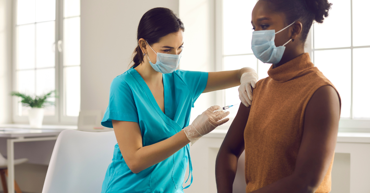 doctor giving a covid-19 vaccine to a patient